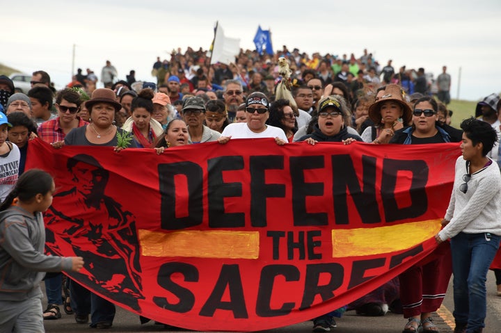 Native Americans march to a burial ground sacred site that was disturbed by bulldozers building the Dakota Access Pipeline.