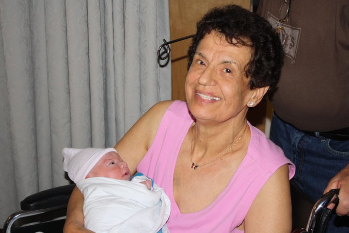 My mother holding Mario after he was born.