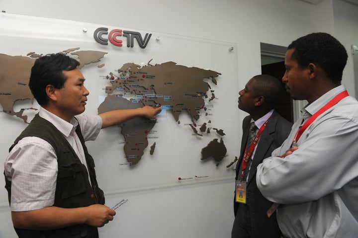 An editor of CCTV Africa in Nairobi talks to a local journalist as he shows how the organization has expanded in different parts of the continent. 