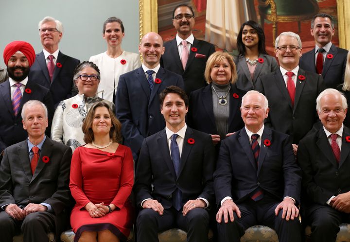 Trudeau poses with his newly appointed cabinet following his inauguration.
