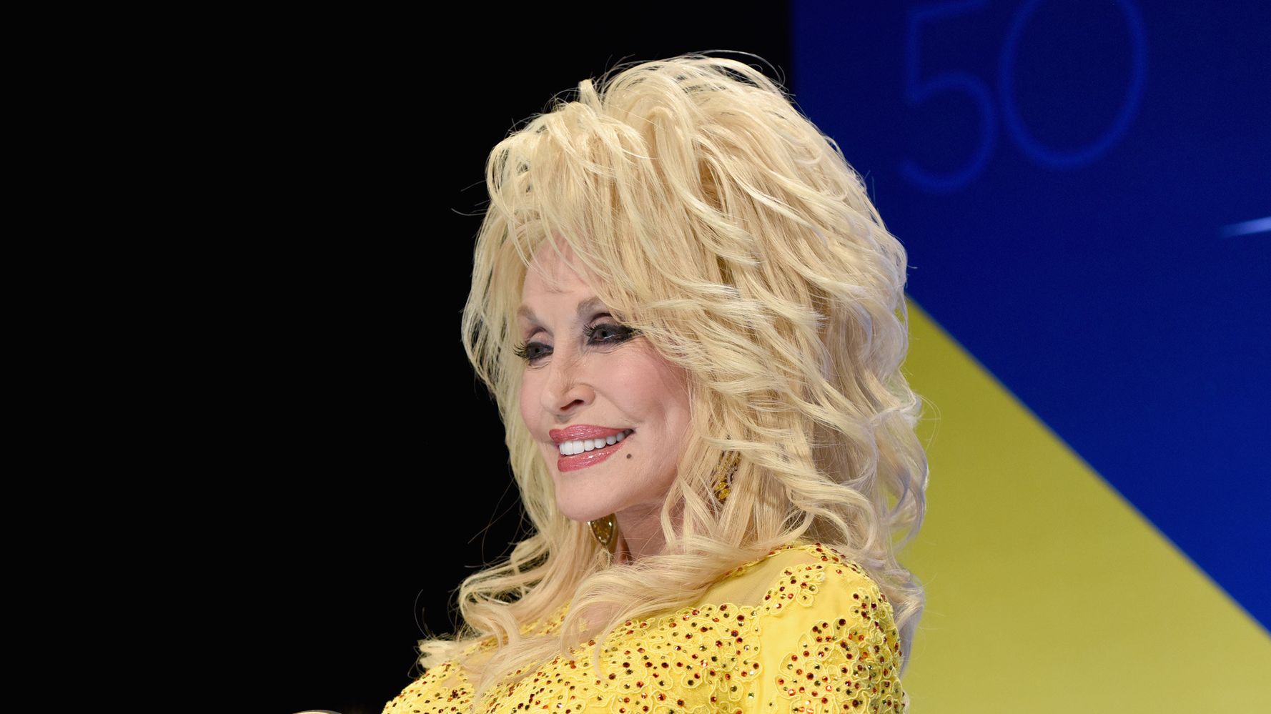 Dolly Parton Shines Like A Thousand Suns In This Yellow Gown.
