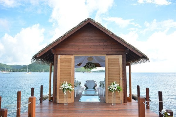 <p><strong>Overwater Wedding Chapel at Sandals Grande St. Lucian in St. Lucia: </strong>This overwater serenity wedding chapel is sure to dazzle, with its picturesque views and unique crossways for exchanging vows. Tucked away at the edge of the property, the open-air chapel is one-of-a-kind (and the first in the Caribbean) and boasts an enchanted interior complete with a river stone altar that holds up to 20 guests. As you float down the natural-aisle towards saying “I do,” we promise you’ll be glad you booked this venue that comes at no extra fee with your wedding package.</p>