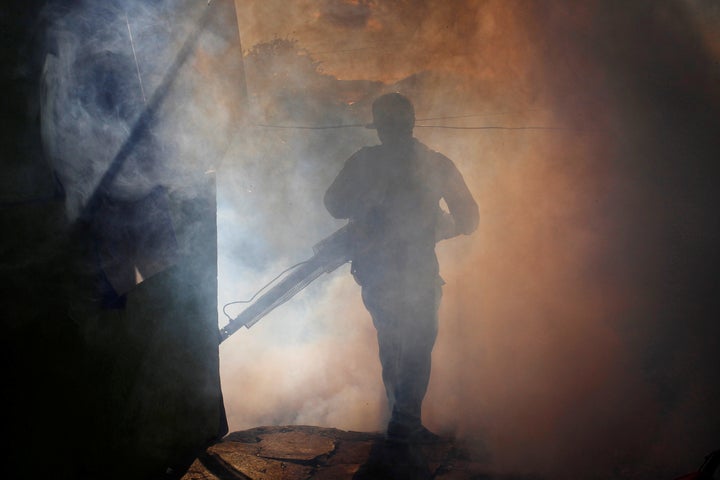 A health ministry worker fumigates a house to kill mosquitoes in Managua, Nicaragua, on Oct. 27.