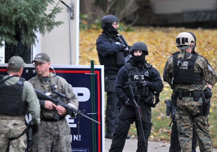 Officers stand guard outside the home of alleged gunman Scott Michael Greene in Urbandale, Iowa, on Nov. 2, 2016.