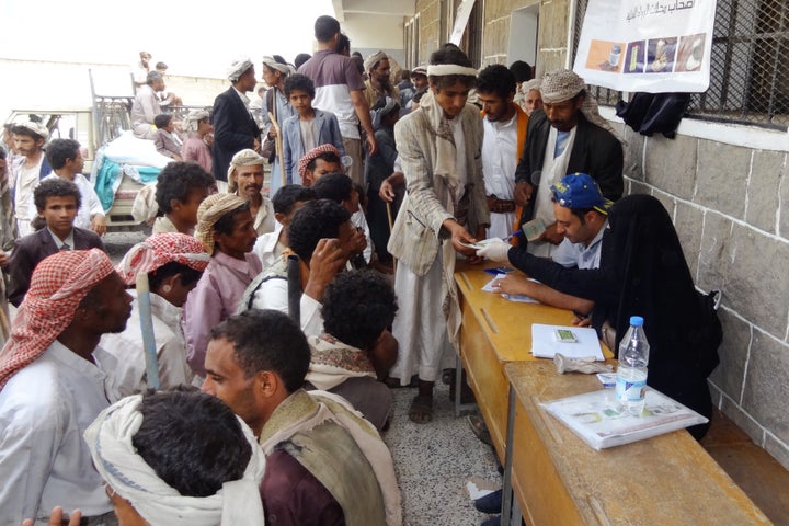 Beneficiary heads of households receive their food vouchers distributed monthly in Haymah Dakhliyah, Sanaa governorate.