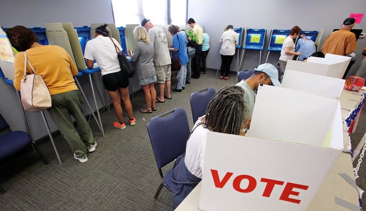 People cast their ballots for the 2016 general elections at a crowded polling station as early voting begins in North Carolina, in Carrboro, North Carolina, U.S., October 20, 2016.