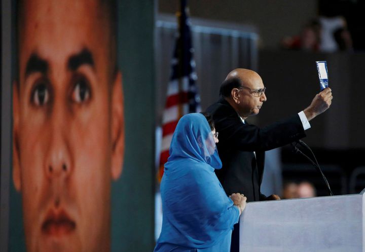Khizr Khan, whose son Humayun (L) was killed serving in the U.S. Army, challenges Donald Trump to read his copy of the U.S. Constitution, at the DNC.