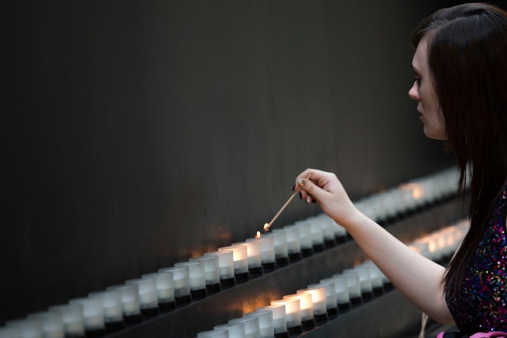 A visitor lights a memorial candle at the United States Holocaust Memorial Museum, May 2, 2016.