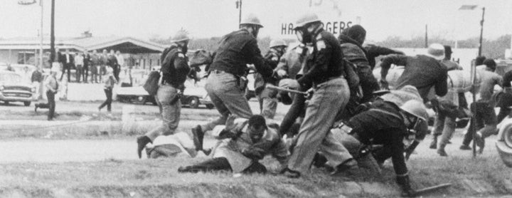 Rep. John Lewis (D-Ga.), then chairman of the Student Nonviolent Coordinating Committee, is beaten by police during a march from Selma, Alabama in 1965. Lewis posted a message on Twitter about how important it is to vote on Tuesday.