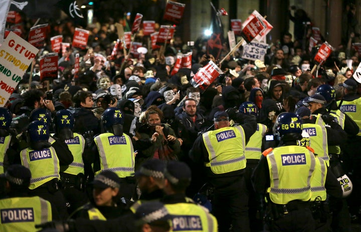 <strong>Police officers control protestors at the Million Mask March in London last year</strong>