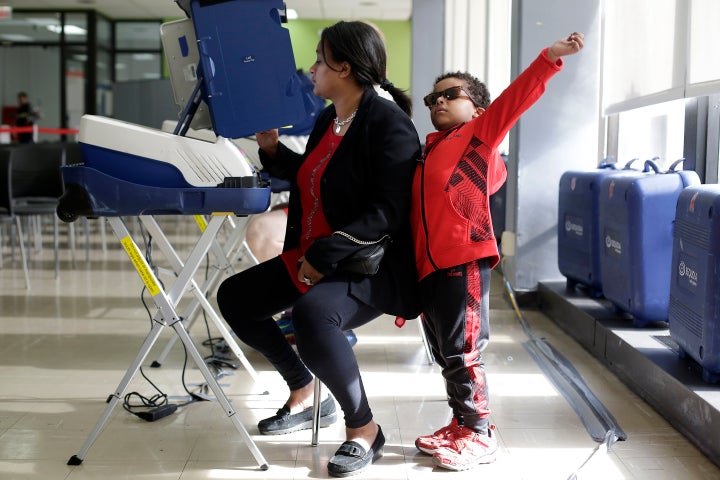 A woman fills out her ballot during early voting at a polling station inside Truman College on Oct. 31, 2016 in Chicago.