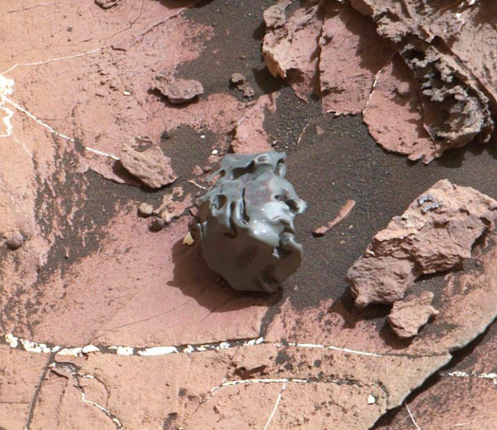 This image, photographed by NASA’s Curiosity Mars Rover on Oct. 30, 2016, shows a dark, smooth-surfaced object. After the golf ball-sized object was examined by laser pulses from Curiosity, it was determined to be an iron-nickel meteorite. The object has been nicknamed ”Egg Rock” after an historic area of Bar Harbor, Maine.