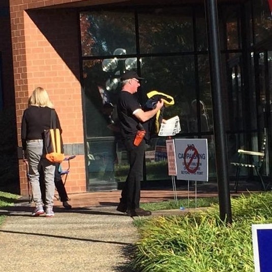 A man carrying a weapon outside of Loudoun County Registrars Office in Leesburg, Virginia.