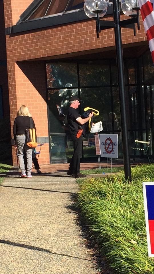 A man carrying a weapon outside of Loudoun County Registrars Office in Leesburg, Virginia.