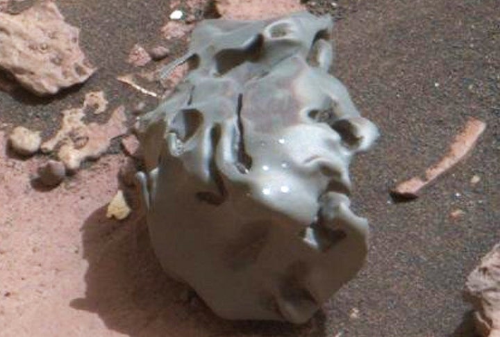 This close-up of the Martian meteorite discovered by the Curiosity rover shows several bright circular marks, the result of t