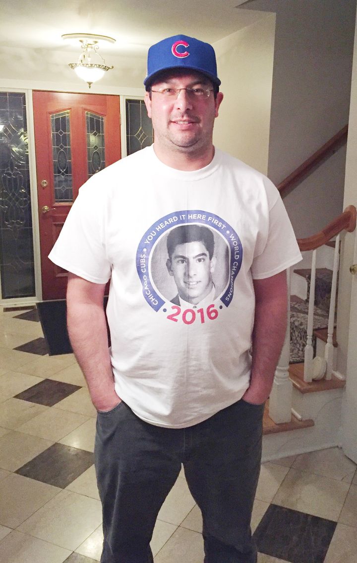 Michael Lee wearing a T-shirt featuring his yearbook photo that features his now-famous prediction the Cubs would win the World Series in 2016.