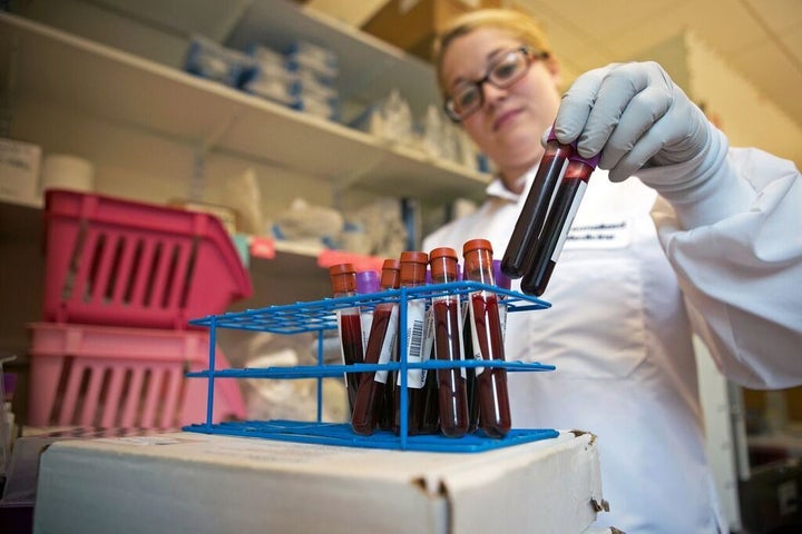 Chelsea Crepeau, technical research assistant at Partners Healthcare Personalized Medicine, prepares vials of human blood for the organization’s Cambridge biobank. Lauren Owens/The Eye