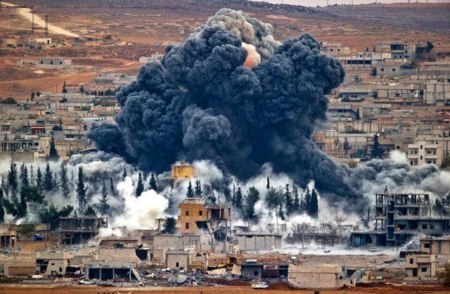 Smoke rises from the Syrian city of Kobani, following an airstrike by the U.S.-led coalition, seen from a hilltop outside Suruc, on the Turkey-Syria border.