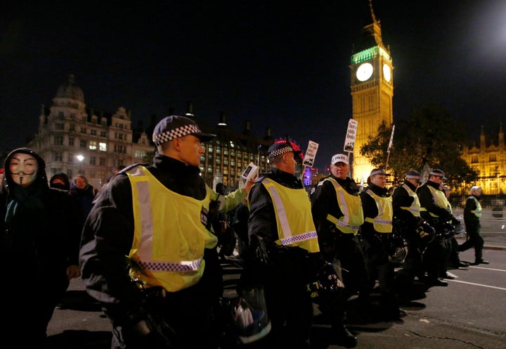 Police officers walk ahead of protesters during the march.