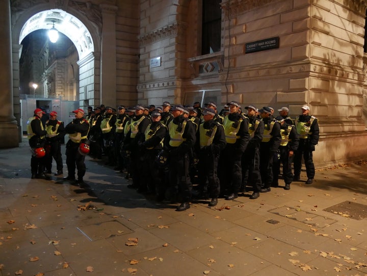 Police line up in front of the Cabinet War Rooms on Whitehall street amid fears of violence at the Million Mask March 2016.