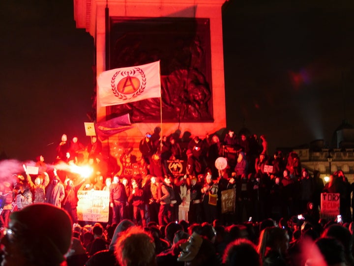 Supporters of hacking group Anonymous gather at the base of Nelsons Column in Trafalgar Square