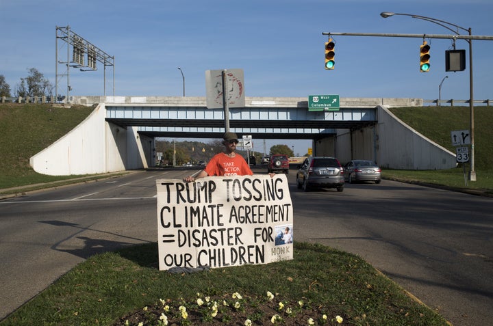 A demonstrator holds a sign in protest of Trump's climate change policies ahead of early voting in Athens, Ohio, on Saturday, Oct. 29.