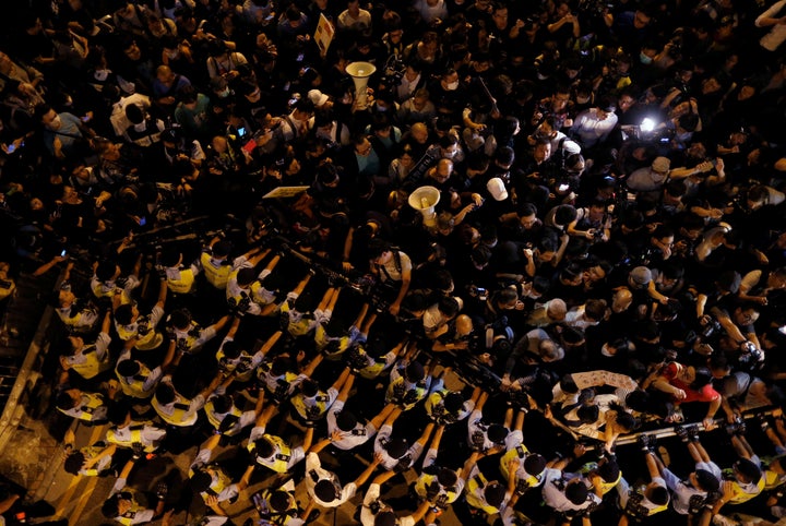 Police stop demonstrators as they protest against what they call Beijing's interference over local politics and the rule of l