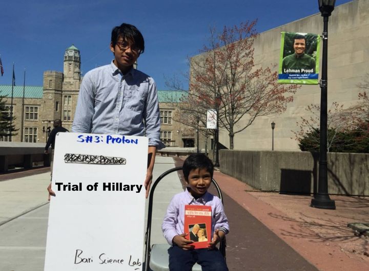 Albert and Isaac, the author’s two sons, are holding book, "Ivy League Love Story (আইভিলিগ লাভ স্টোরি)" on Lehman College’s campus.