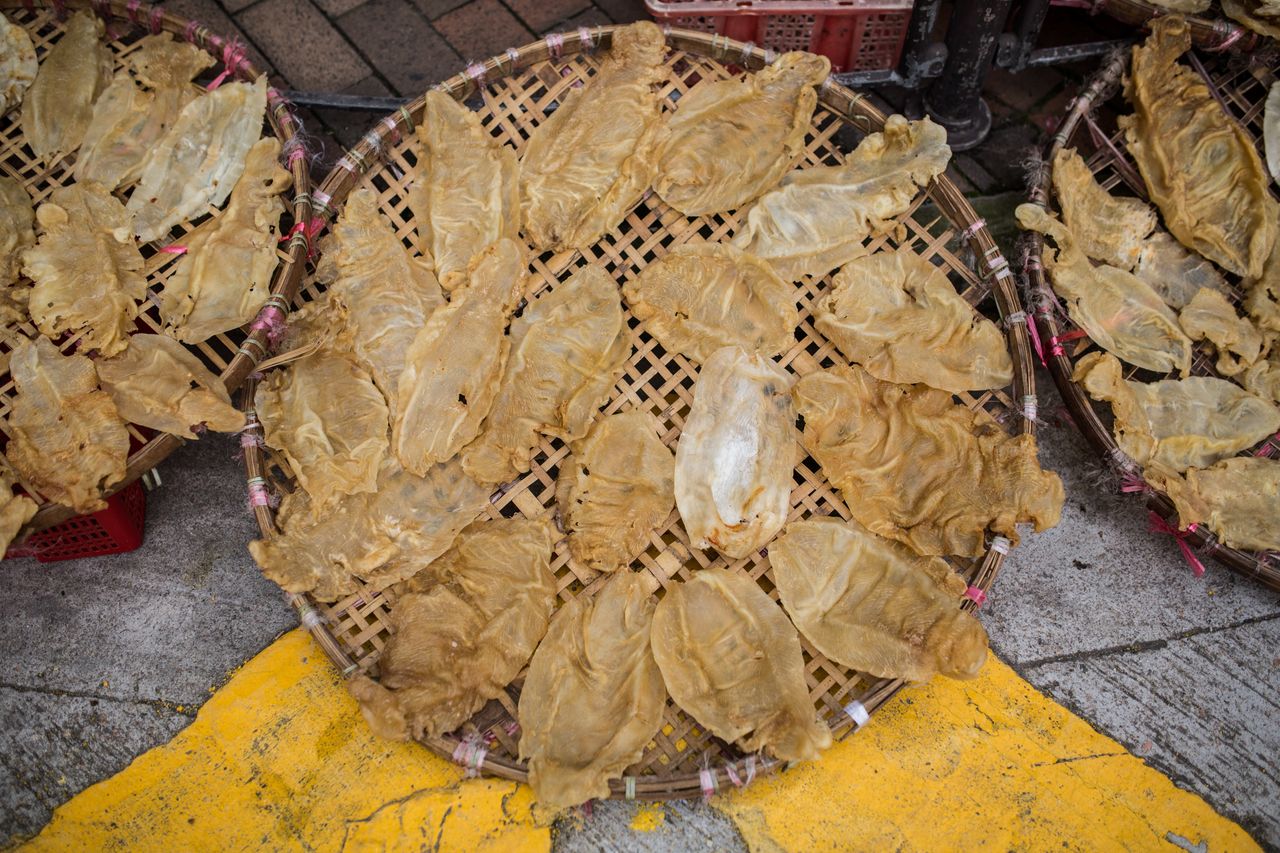 This March 2016 photo shows fish maws placed in a basket to dry outside a dried goods shop in Hong Kong. The maws of totoaba, a critically endangered fish, are sold for thousands of dollars on the black market in Asia.