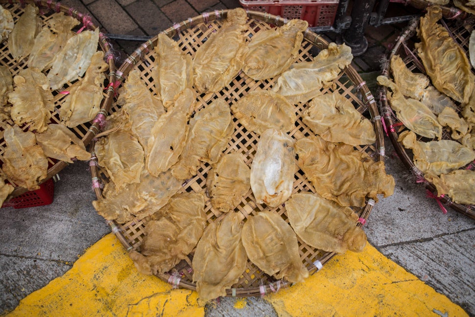 This March 2016 photo shows fish maws placed in a basket to dry outside a dried goods shop in Hong Kong. The maws of totoaba,