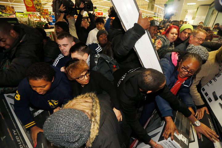 Shoppers fight over deals at an Asda store in 2014. The retail giant pulled out of Black Friday last year
