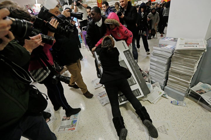 Frenzied scenes as shoppers fight over deals on Black Friday 2014