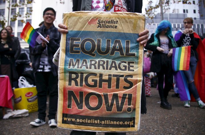 A gay-rights activist holds a banner during a rally supporting same-sex marriage in Sydney, Australia May 31, 2015.
