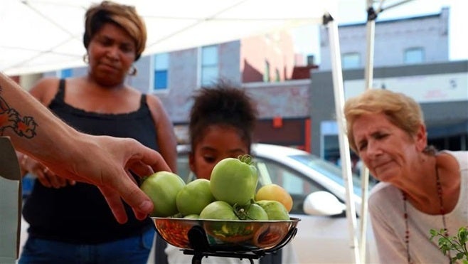 Shoppers buy produce at a farmers market in St. Louis, Missouri. The market is one of 3,500 in the U.S. that accept food stamps.