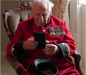 Mouqué examines a medal that was awarded to him by the French mayor of Armentières.