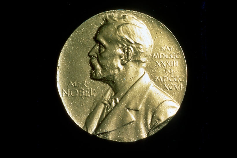 Front of the medal of the Nobel Prize, featuring a profile of Alfred Nobel, isolated on a black background.