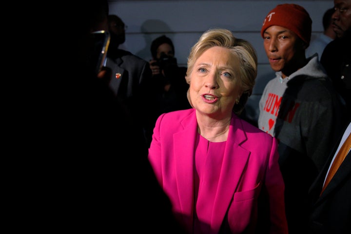 U.S. Democratic presidential nominee Hillary Clinton and the musician Pharrell Williams, right, greet students at North Carol