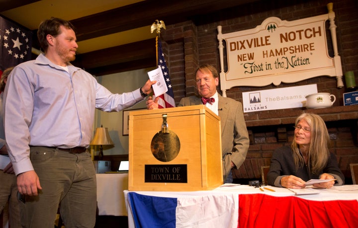 Dixville Notch's first voter Clay Smith drops his ballot into the box