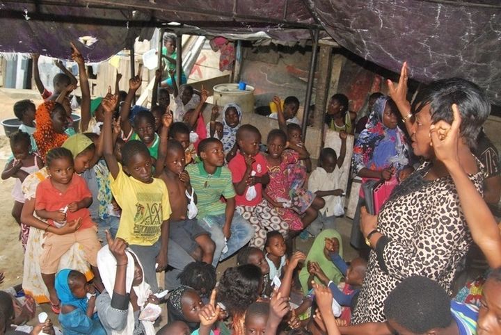 <p> CEE-HOPE’s founder, Betty Abah addressing children in Monkey Village, one of the several slums in Lagos where CEE-HOPE works with vulnerable children</p>