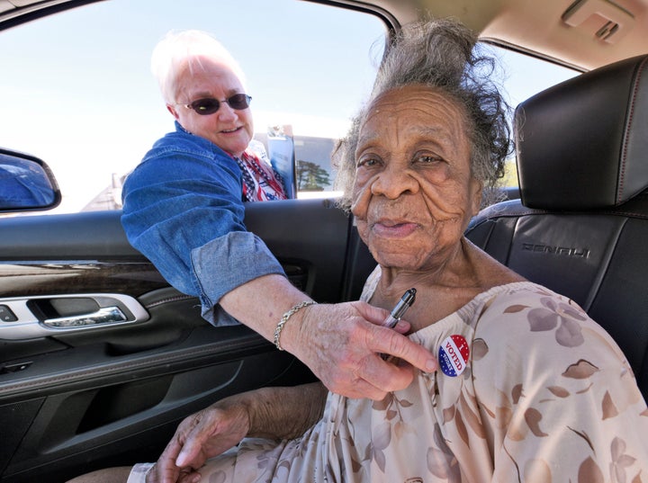 Grace Bell Hardison receives an "I Voted Today" sticker from election official Elaine Hudnell. 