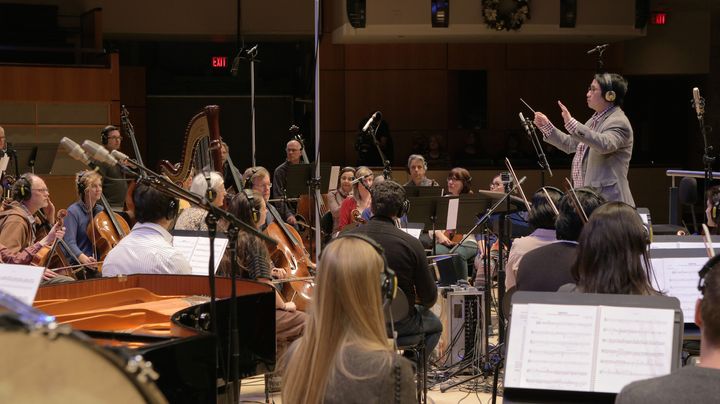 Darren Fung conducting the orchestra he led for “The Great Human Odyssey” score
