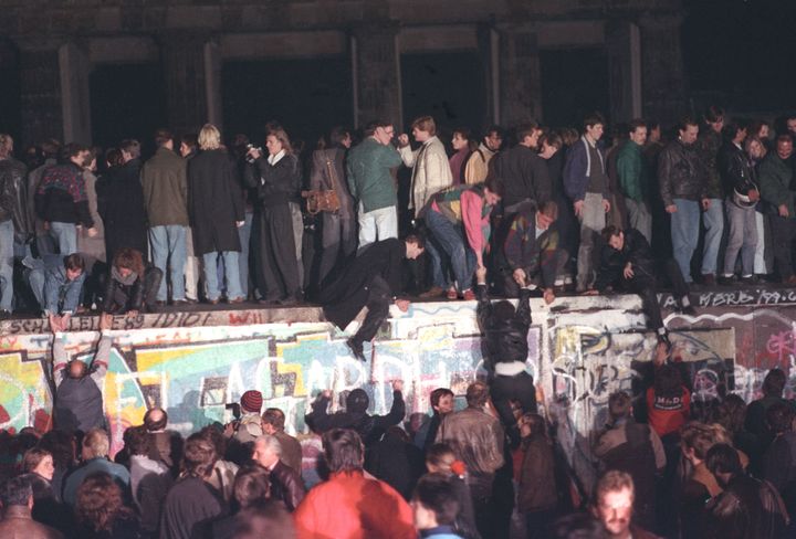 West Berlin citizens continue their vigil atop the Berlin Wall.