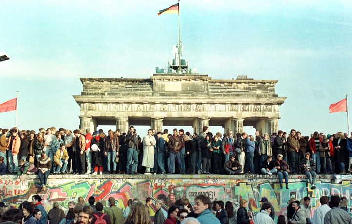 West Berlin citizens continue their vigil on top of the Berlin Wall in November 1989.