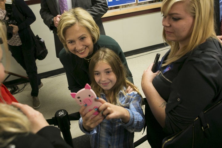 Former Secretary of State Hillary Clinton takes a selfie with 9 years old Katie Williamson of Franconia, New Hampshire at the Littleton Rural Economic Roundtable at Littleton High School in Littleton, New Hampshire October 29, 2015.