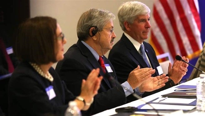 Oregon Gov. Kate Brown, Iowa Gov. Terry Branstad and Michigan Gov. Rick Snyder listen to a presentation by Chinese President Xi Jinping. Snyder has made five trips to China to coax companies to invest and locate facilities in his state.