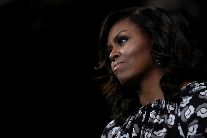 Obama looks on as Clinton speaks during the campaign.