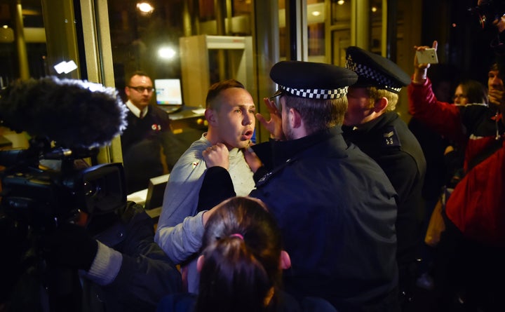 The EDL supporter is restrained by police