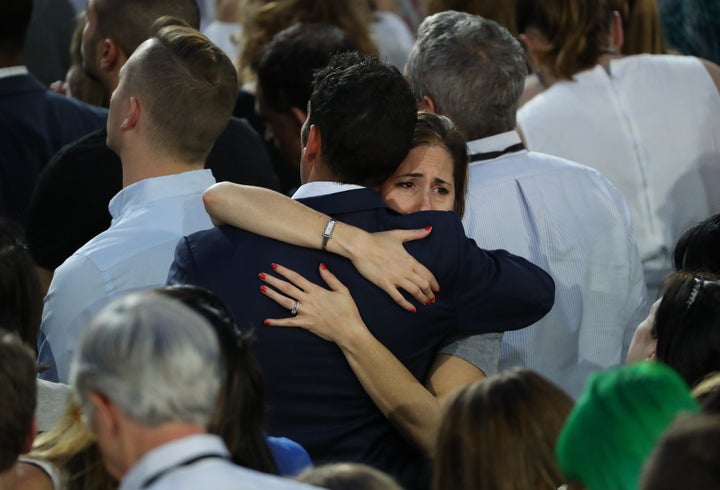 Attendees embrace during an election night party for 2016 Democratic Presidential Candidate Hillary Clinton at the Javits Center in New York, U.S., on Tuesday, Nov. 8, 2016.