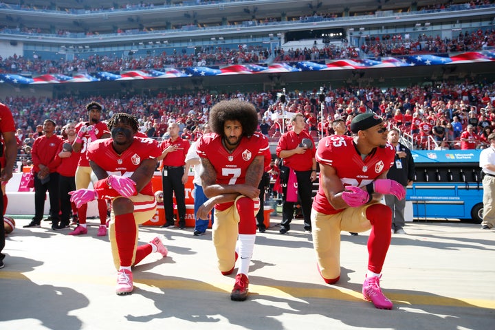 Support grew for quarterback Colin Kaepernick's protests. Eli Harold, left, and Eric Reid, right, of the San Francisco 49ers kneel with him during the national anthem on Oct. 23.