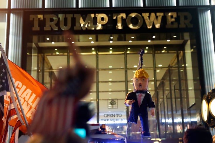<strong>Protesters hoist an effigy of Trump outside Trump Tower</strong>